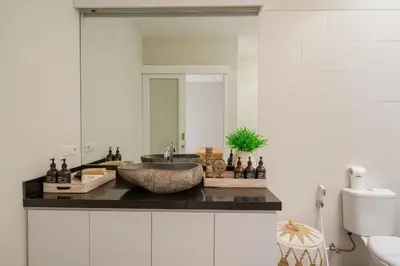 a bathroom with a sink and a mirror at The Eclipse Villas - The Luxurious 2BR Private Pool Canggu Getaway in Canggu