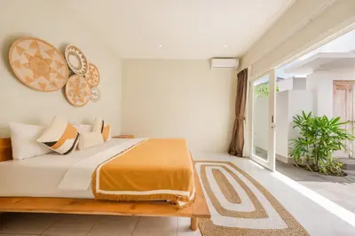 a bedroom with a bed and a large window at The Eclipse Villas - The Luxurious 2BR Private Pool Canggu Getaway in Canggu