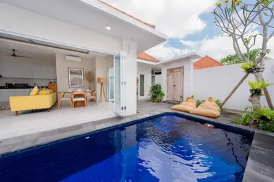 a villa with a swimming pool in front of a house at The Eclipse Villas - The Luxurious 2BR Private Pool Canggu Getaway in Canggu