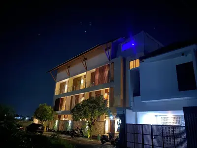a building with a blue light on it at night at SONGOKU HOUSE APARTMEN in Pesanggaran