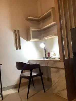 a desk and a chair in a room at SONGOKU HOUSE APARTMEN in Pesanggaran