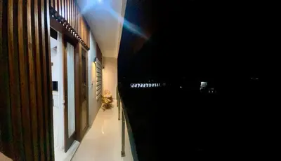 a hallway of a building with a dog sitting on the floor at SONGOKU HOUSE APARTMEN in Pesanggaran