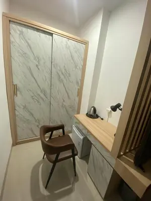 a chair in a bathroom with a large window at SONGOKU HOUSE APARTMEN in Pesanggaran