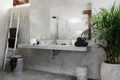 a bathroom with a sink and a mirror at Surflodge Limasan Bali in Kerobokan