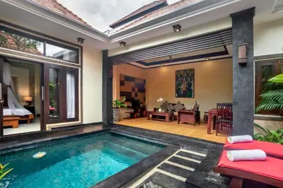 a swimming pool in a villa with a living room at Swaran 1 BR Private Pool Villa in Seminyak