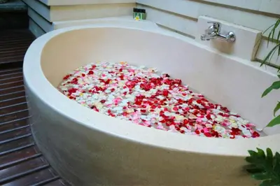 a bath tub filled with sprinkles in a bathroom at Catra 3 BR Private Pool Villa in Seminyak