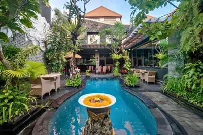 a pool at a hotel with a fountain in the middle at Catra 3 BR Private Pool Villa in Seminyak