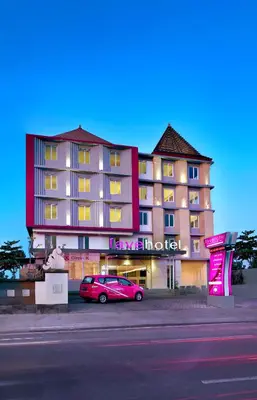 a red car parked in front of a hotel at favehotel Sunset Seminyak in Seminyak