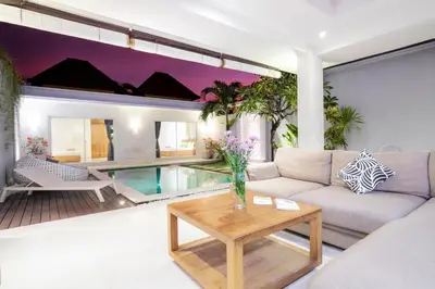 a living room with a couch and a table at Villa Angela in Seminyak