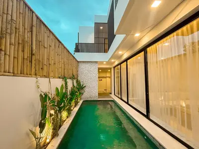 an indoor swimming pool in the middle of a house at Villa Prada II 3BR Villa Near to Beach in Seminyak in Seminyak
