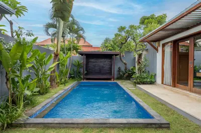 a swimming pool in the backyard of a villa at Kings Villas Sanur by Moria in Denpasar