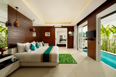 a bedroom with a bed and a pool at Bajra Bali Villa Seminyak in Seminyak
