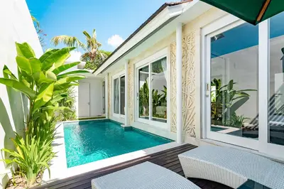 a swimming pool in the middle of a house at Bajra Bali Villa Seminyak in Seminyak