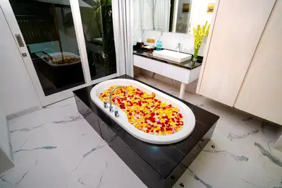 a bathroom with a bath tub filled with candy peppers at Bajra Bali Villa Seminyak in Seminyak