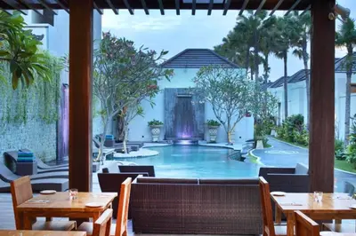 a resort with a swimming pool with tables and chairs at Zefanya 2 BR Private Pool Villa in Seminyak