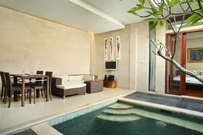a living room with a swimming pool next to a house at Zefanya 2 BR Private Pool Villa in Seminyak