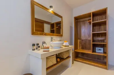 a bathroom with a sink and a mirror at Villa Lima - 5 bdrs, BBQ, Living room with Ac and private pool in Seminyak