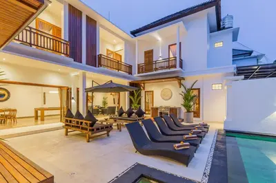 a villa with a swimming pool and a house at Villa Lima - 5 bdrs, BBQ, Living room with Ac and private pool in Seminyak