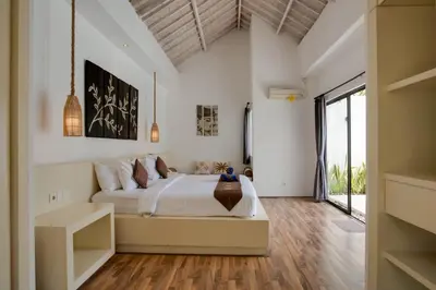 a bedroom with a bed and a large window at Anakula 1 - Modern 2 BR Villa, Seminyak in Seminyak