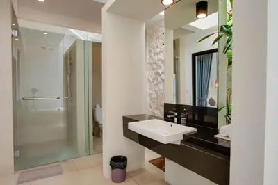 a bathroom with a sink and a shower at Anakula 1 - Modern 2 BR Villa, Seminyak in Seminyak