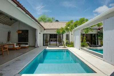 a swimming pool in a villa with a house at Anakula 1 - Modern 2 BR Villa, Seminyak in Seminyak
