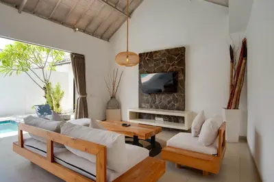 a living room with a couch and a table at Anakula 1 - Modern 2 BR Villa, Seminyak in Seminyak