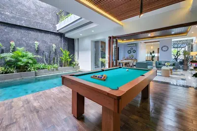 a pool table in the middle of a living room at Villa Rumpi Seminyak by Nagisa Bali in Legian
