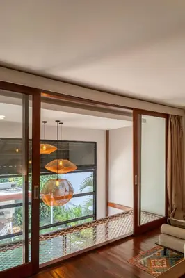 a living room with a large window and a chandelier at Stylish Tropical Villa 2 Br , Canggu , 400m To Finn Beach in Canggu