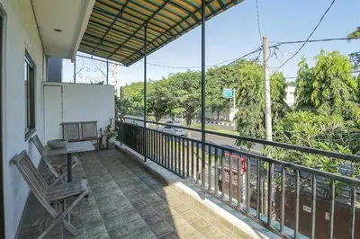a balcony with a bench and a view of a street at Tuban Torres Accommodation in Kuta