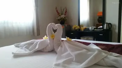 two swans made out of white sheets on a bed at Tuban Torres Accommodation in Kuta