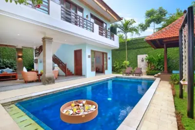 a villa with a swimming pool and a house at Luxury 3BR Private Pool Villa in Seminyak