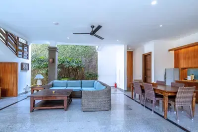 a living room with a blue couch and a table at Luxury 3BR Private Pool Villa in Seminyak