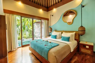 a bedroom with a large bed and a mirror at Beautiful 1BR Private Pool Villa in Seminyak