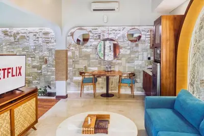 a living room with a blue couch and a table at Beautiful 1BR Private Pool Villa in Seminyak
