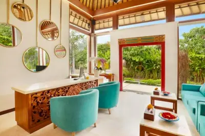 a living room with blue chairs and a counter at Beautiful 1BR Private Pool Villa in Seminyak