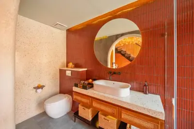 a bathroom with a sink and a toilet and a mirror at Modern 1BR Private Pool Villa With Bathtub in Seminyak