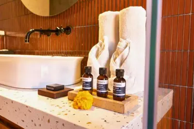 two bottles of alcohol sitting on a counter in a bathroom at Modern 1BR Private Pool Villa With Bathtub in Seminyak