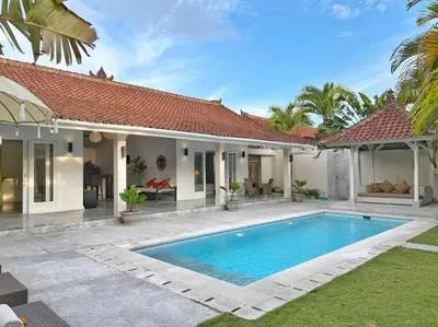 a villa with a swimming pool in front of a house at Fully renovated villa 3BR in Seminyak - Oberoi in Seminyak