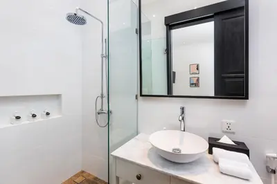 a bathroom with a sink and a glass shower at Villa Jabula in Seminyak