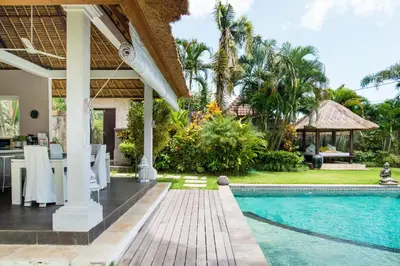 a villa with a swimming pool and a house at Villa Bliss a Paradise of Three Independent Villas in Canggu