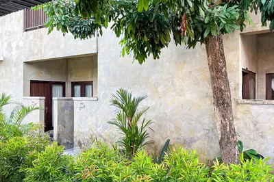 a stone building with a tree in front of it at Sekeca Coliving in Kuta