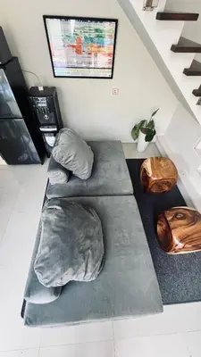 a couch with pillows on the floor in a room at Oasis Villa Canggu in Kerobokan