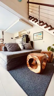 a bedroom with two beds with wooden furniture at Oasis Villa Canggu in Kerobokan