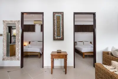 a room with two beds and two mirrors at Casa Yenny Balinese Style Villa by GLOBALSTAY - Seminyak x Kuta x Canggu in Seminyak