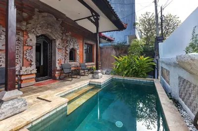 a house with a swimming pool in front of a house at Casa Yenny Balinese Style Villa by GLOBALSTAY - Seminyak x Kuta x Canggu in Seminyak