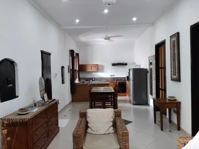 a living room with a table and a kitchen at Casa Yenny Balinese Style Villa by GLOBALSTAY - Seminyak x Kuta x Canggu in Seminyak