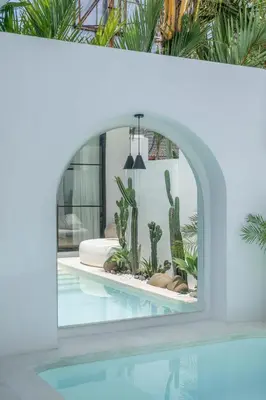 a room with a pool with cactus and a mirror at Villa Golden Canggu - Modern Chic 2BR Villa Near Finns Recreation Club in Canggu