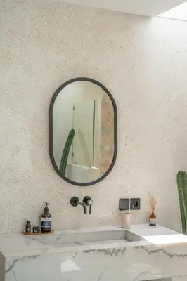 a bathroom with a sink and a mirror on the wall at Villa Golden Canggu - Modern Chic 2BR Villa Near Finns Recreation Club in Canggu