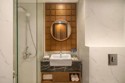 a bathroom with a sink and a mirror at Lavaya Resort Nusa Dua Bali in Nusa Dua