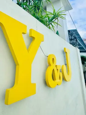 a yellow k sign on the side of a building at Y&J in Seminyak